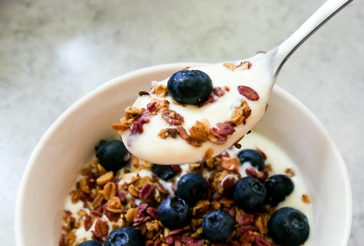 Blueberries and granola served over yogurt