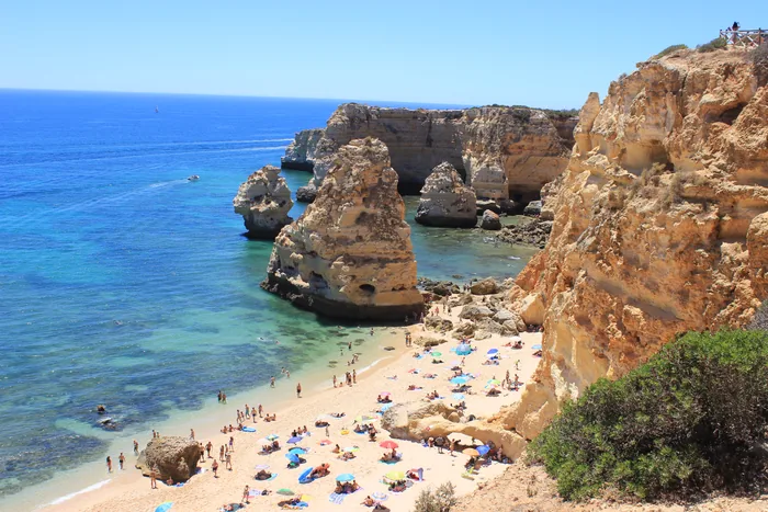 Golden cliffs and bright blue sea at Praia da Marinha, Algarve