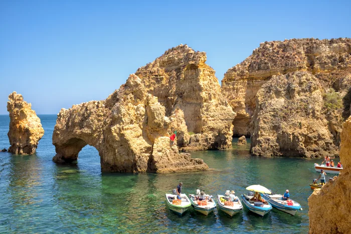 Small boats beside the sea arches of Ponta da Piedade, Lagos