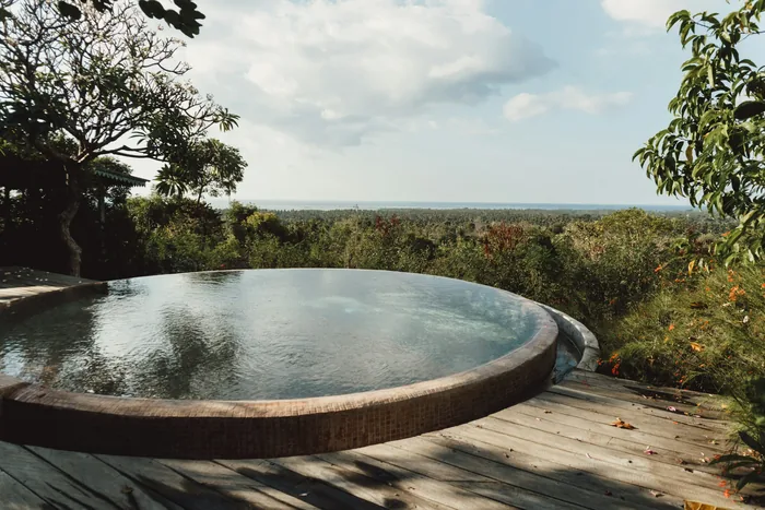 A pool overlooking tropical greenery in Bali
