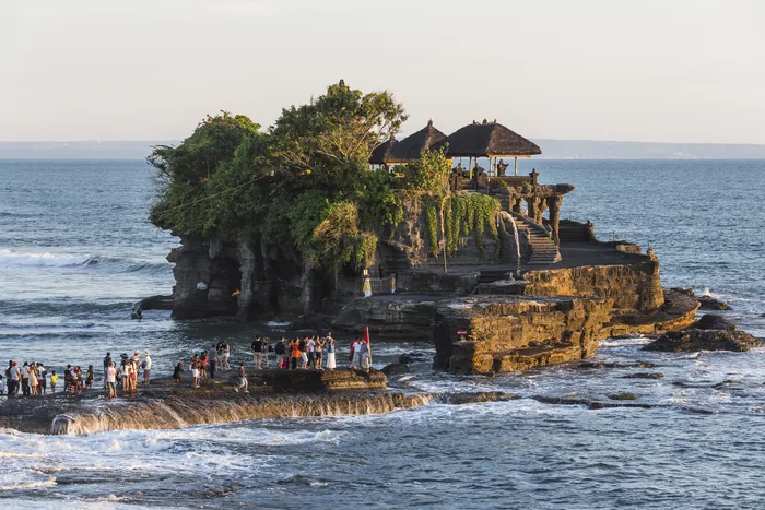 Pura Tanah Lot on its coastal rock at sunset, Bali