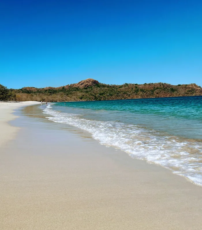Gentle surf on a sunlit beach in Guanacaste, Costa Rica