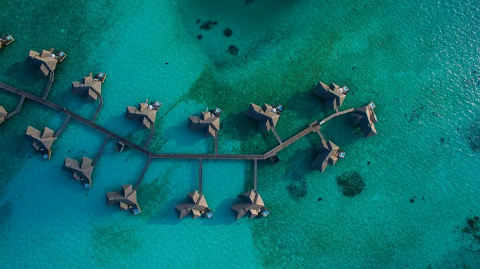 Overwater villas above a turquoise lagoon in the Maldives