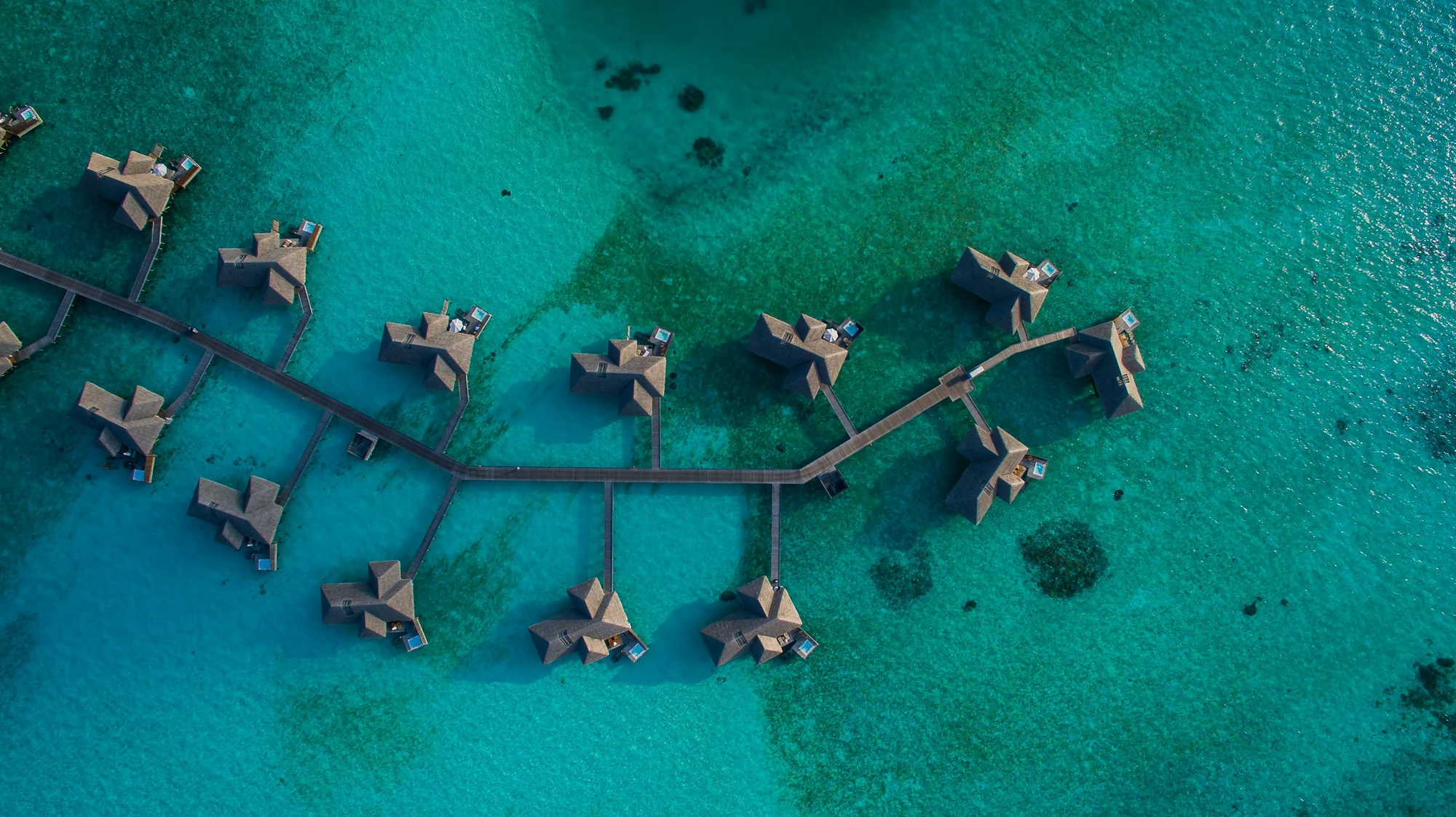 Overwater villas above a turquoise lagoon in the Maldives